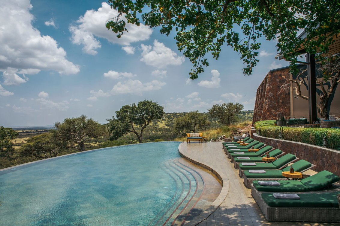Meliá Serengeti Lodge — Pool loungers overlooking the Serengeti.