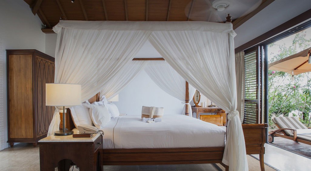 The Residence Zanzibar — Villa bedroom with a canopy bed.