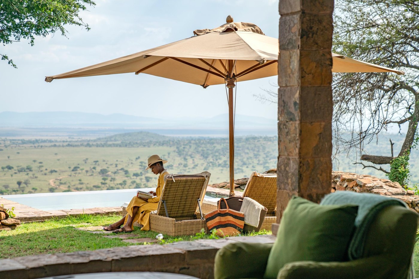 Singita Sasakwa Lodge — Private terrace seating with reserve views.