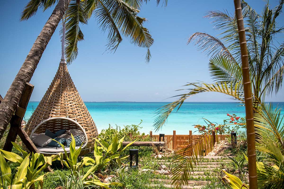 Zuri Zanzibar — Beachside seating beneath the palms.